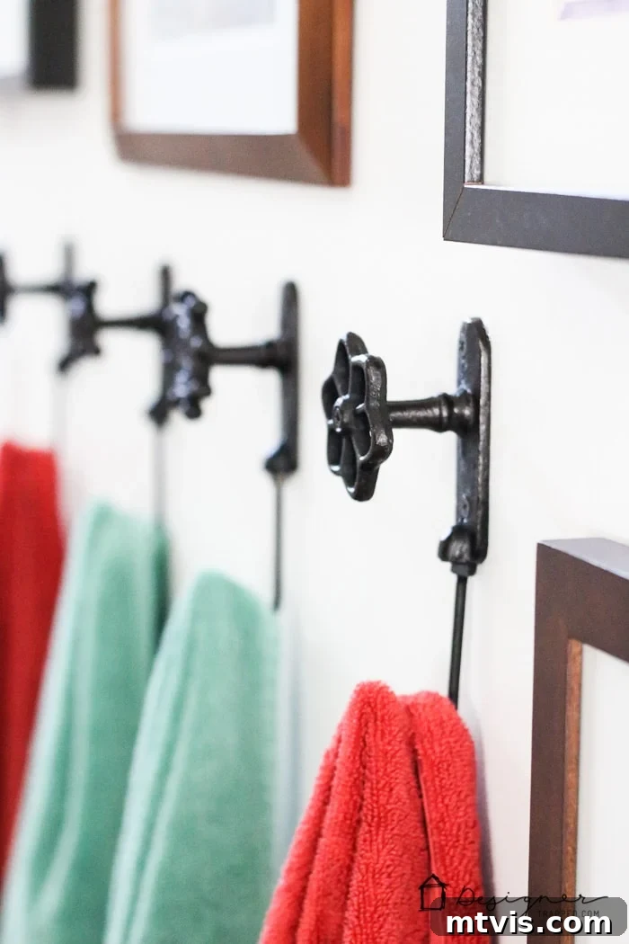 Functional and charming towel hooks add a practical and decorative element to the DIY bathroom remodel, perfect for a family-friendly space.