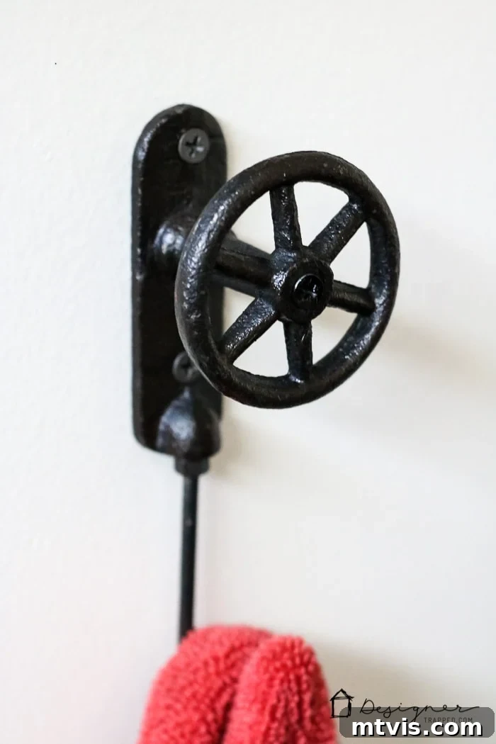 A closer view of the thoughtfully chosen towel hooks, emphasizing their aesthetic appeal and functionality in the newly renovated DIY bathroom.