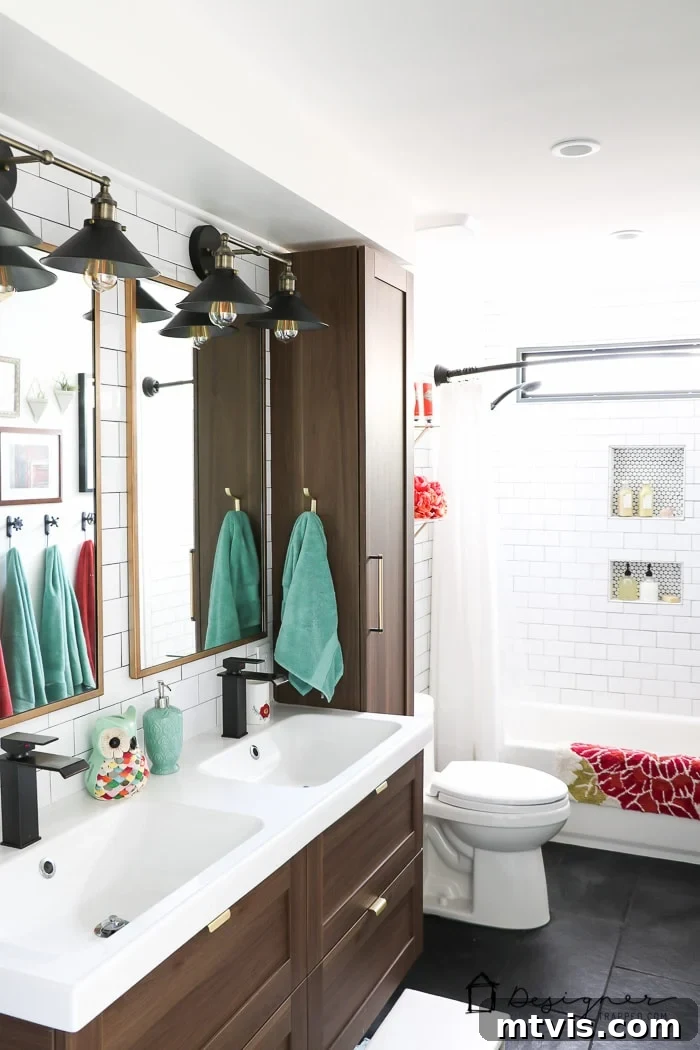 A closer look at the stunning DIY bathroom remodel, highlighting the modern subway tile shower, sophisticated black slate flooring, and custom details meticulously installed by the homeowners.