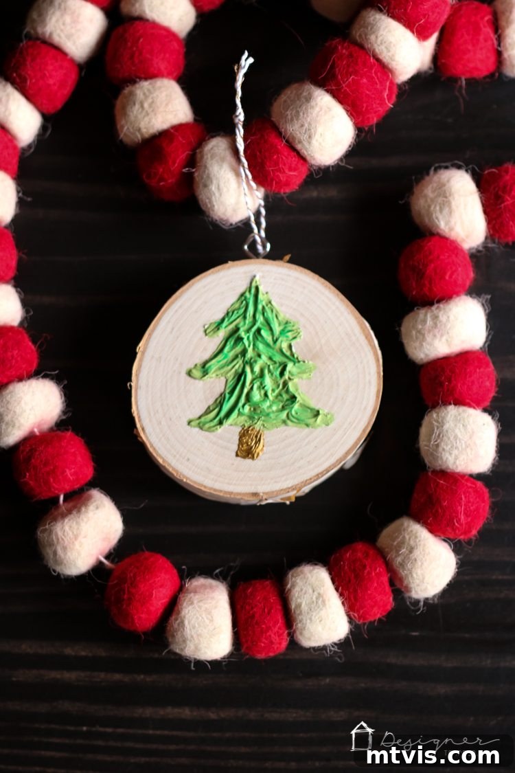 Create Stunning Textured Holiday Decor 11 Two beautiful handmade textured Christmas tree ornaments hanging together, displaying their unique caulk texture.