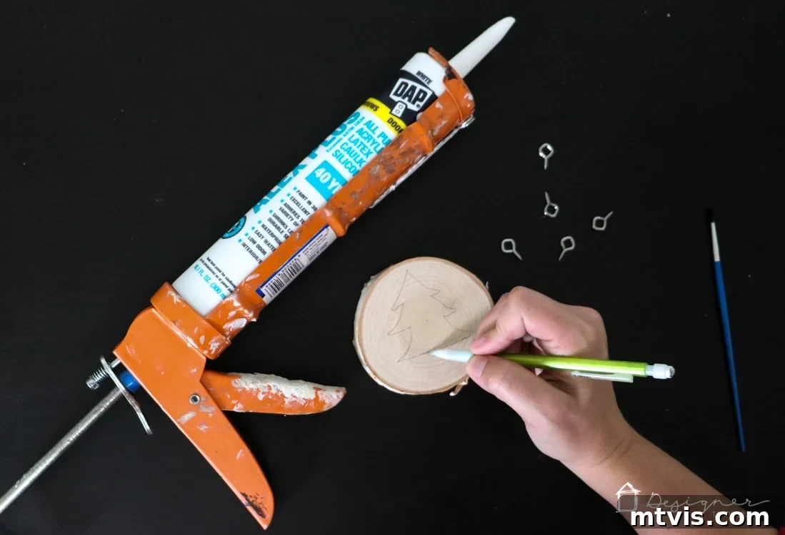 Create Stunning Textured Holiday Decor 4 Sketching a Christmas tree outline on a wood slice with a pencil as the first step for a DIY textured ornament.