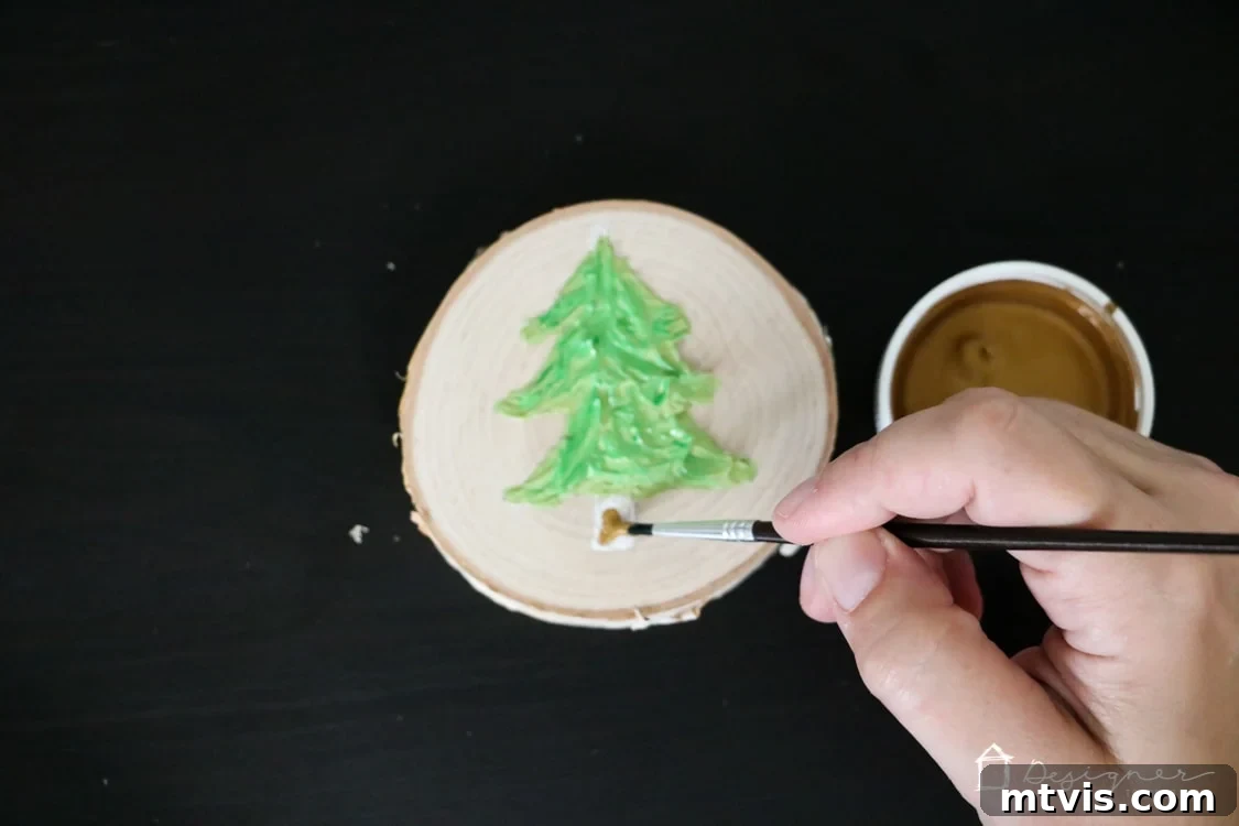 Create Stunning Textured Holiday Decor 8 Close-up of the painted caulk Christmas tree ornament, showing the vibrant green and metallic gold details.