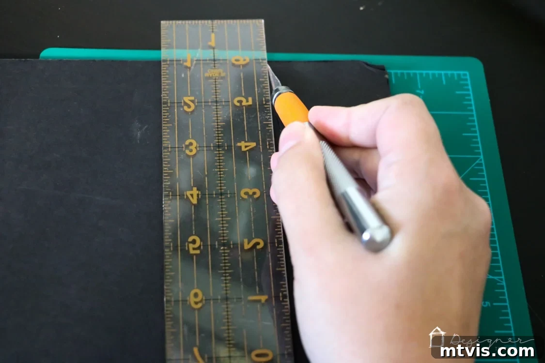 Handcrafted Christmas Countdown 5 Detailed shot of cutting foam board with a craft knife for a DIY project.