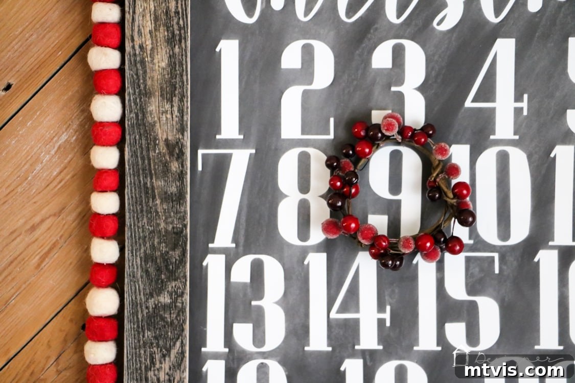 Handcrafted Christmas Countdown 10 A festive mini berry wreath with a wire hook, ready to be used as a marker on the DIY Christmas countdown calendar.