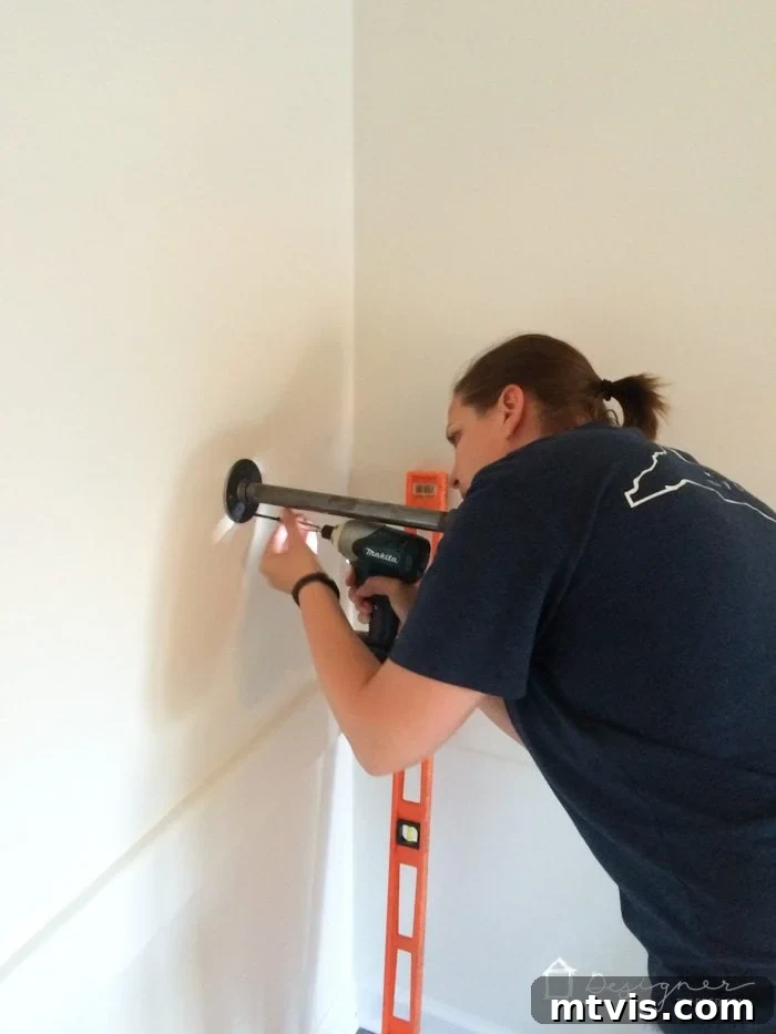 Your Ultimate Guide To Effortless Pipe Shelves 5 Securing the second industrial pipe shelf bracket to the wall