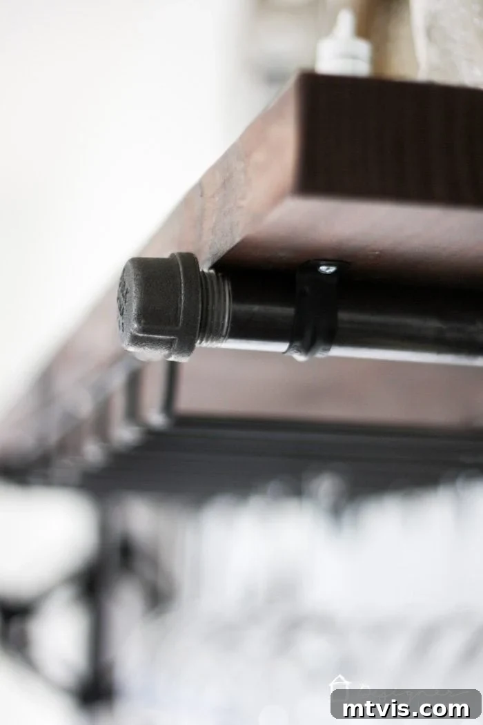 Your Ultimate Guide To Effortless Pipe Shelves 6 Attaching the wooden shelf to the industrial pipe brackets with metal straps