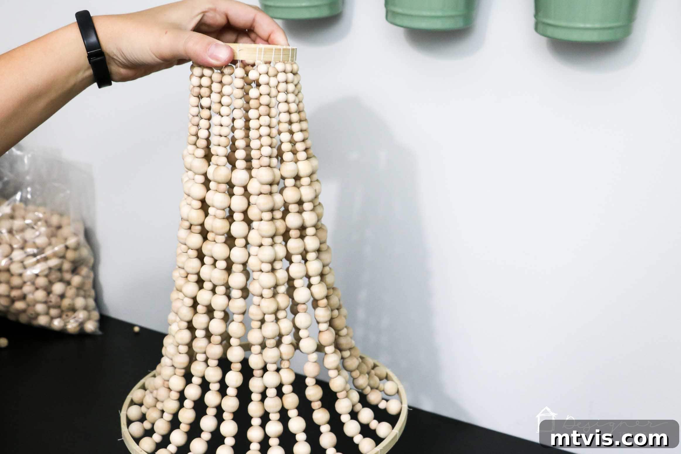 OMG, I love this DIY chandelier made from wood beads. It looks like it may take a while, but it doesn't look hard! I've wanted a wood bead chandelier but they are so expensive. Totally making this.