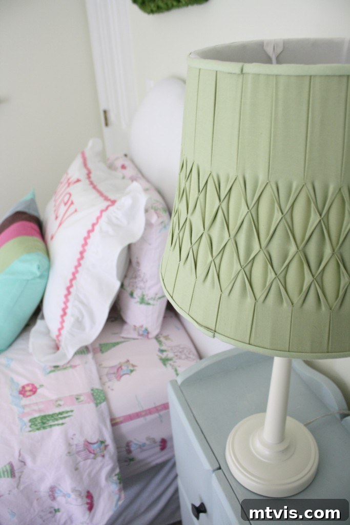 Princess Room Lighting & Decor Details Elegant chandelier and classic bedside table with lamp in a princess room