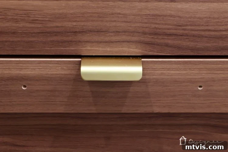Ikea Cabinet Doors and Drawers Hack: Unlocking Custom Mounting Options 3 Close-up 'before' view of pre-drilled holes on Ikea cabinet door, showing the initial challenge for custom hardware installation.