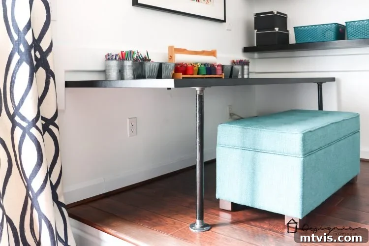 Overview of a bright, kid-friendly workspace featuring a DIY pipe desk, storage bench, and natural light.