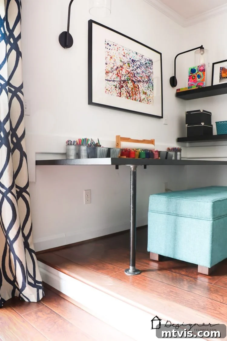 Close-up of the DIY pipe desk setup, showcasing its sturdy industrial legs and sleek black tabletop.