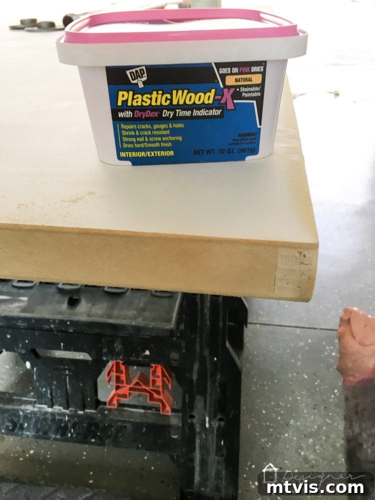 Applying DAP Plastic Wood-X wood filler to the raw edges of a hollow core door to achieve a smooth desk surface.