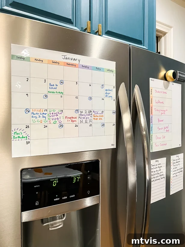 A colorful dry erase calendar creates a family command center on the refrigerator.