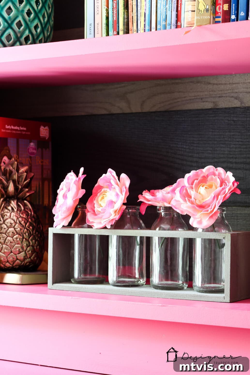 Billy Bookcase Brilliance: IKEA Hacks for Ultimate Storage 10 A close-up of an IKEA Billy bookcase shelf showcasing a brass pineapple and a small bottle with pink flowers, adding decorative flair.