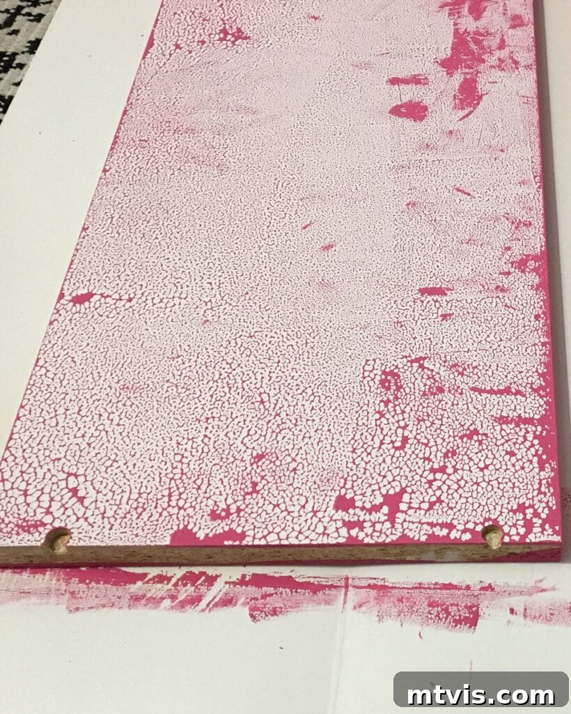 Close-up photo of paint beading up on an unprimed IKEA laminate shelf, illustrating poor adhesion
