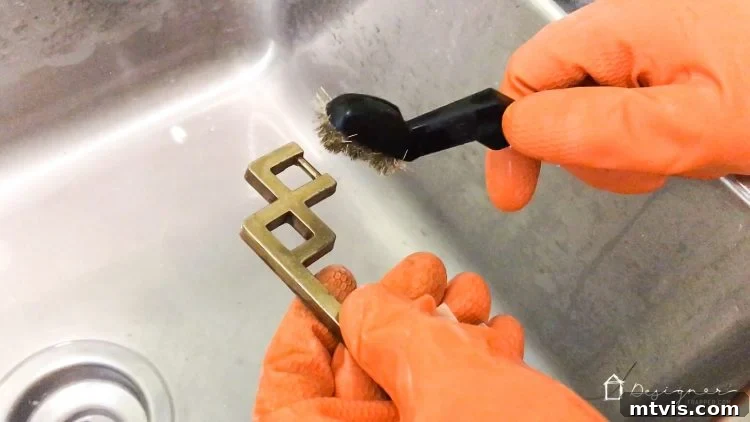 Transform Your Furniture: The DIY Restoration Guide 4 Detailed shot of brass campaign hardware being cleaned with Bar Keeper's Friend.