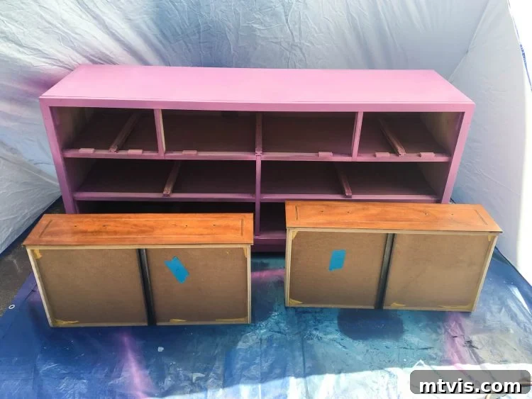 Transform Your Furniture: The DIY Restoration Guide 7 Dresser drawers being painted with a sprayer for a smooth finish.