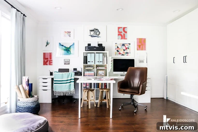 Smart IKEA Desk Upgrades on a Budget 11 A beautifully organized double desk features a central table flanked by two workstations, complete with a comfortable leather wheeled chair, an abundance of drawers and shelving units, and a stylish gallery wall, all set against a dark wood floor. This IKEA desk hack is perfectly designed for both office work and creative crafting endeavors. The words