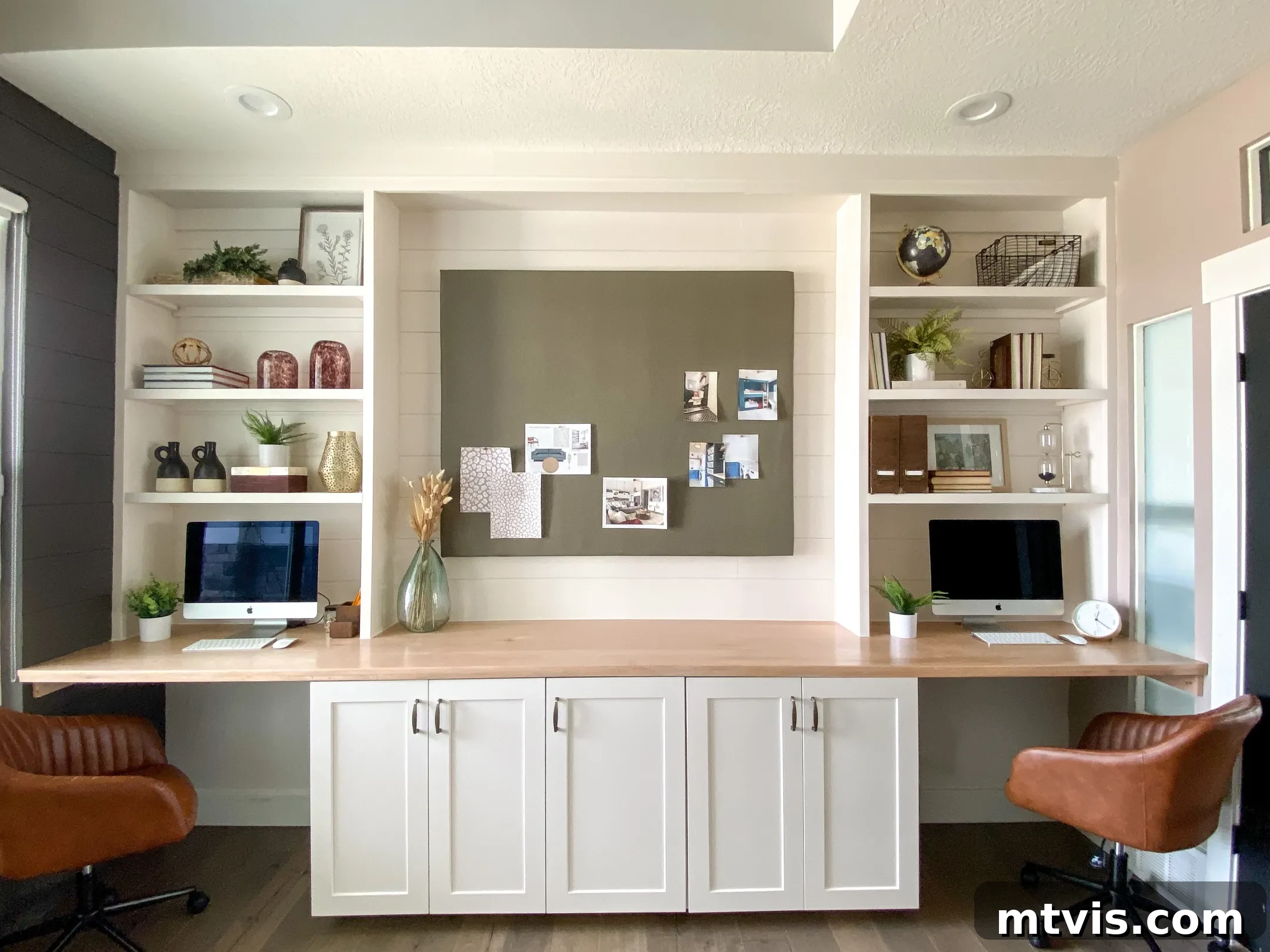 Smart IKEA Desk Upgrades on a Budget 16 A sprawling wood countertop extends the length of the wall, featuring built-in cabinets underneath and tall bookshelves on either side, skillfully creating a two-person work area from an innovative IKEA desk hack.