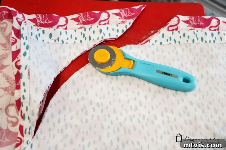 Transform Your Bed with a Flat Sheet Canopy 6 Using a rotary cutter to expertly cut rounded corners on the stacked flat sheets for the canopy.