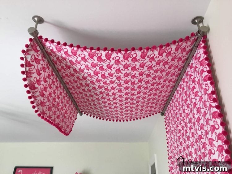 Transform Your Bed with a Flat Sheet Canopy 9 The finished DIY bed canopy installed with ceiling-mounted curtain rods, creating a cozy and stylish nook.