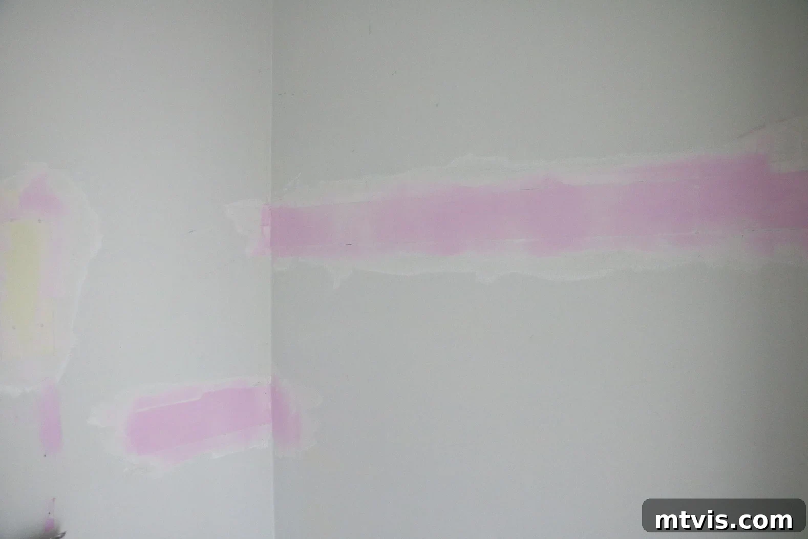 Closet walls after spackling and before painting, showing smooth repairs