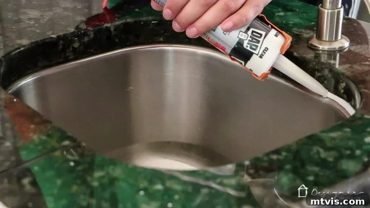 The newly applied caulk drying around the sink, showing a clean and updated appearance. Fresh caulk after application.