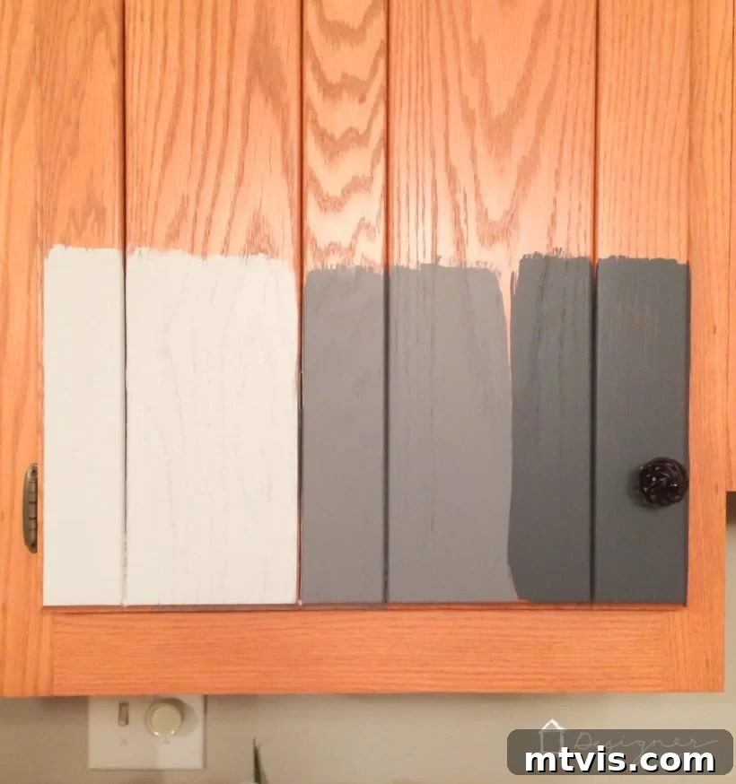 Is Painting Your Kitchen Cabinets Right for You? Essential Questions Before You Begin 5 Multiple paint samples applied to a cabinet door, demonstrating adhesion tests and color choices.