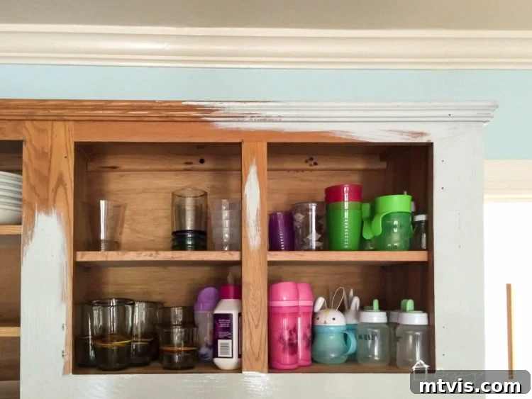 Is Painting Your Kitchen Cabinets Right for You? Essential Questions Before You Begin 9 Detailed shot of a freshly painted kitchen cabinet, highlighting the finish and hardware.