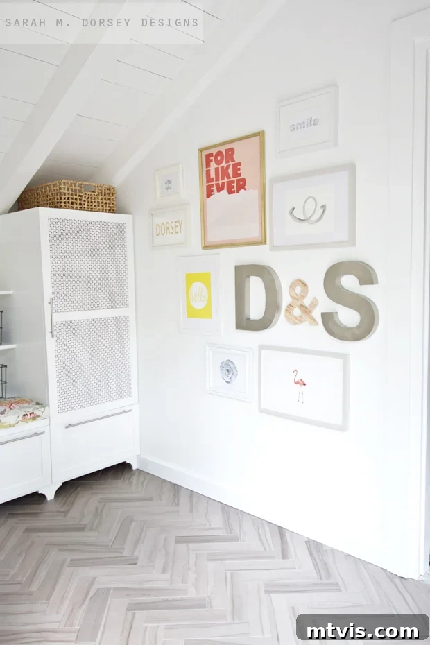 Transform Your Space: 27 Gallery Wall Ideas and Practical Hacks 11 A contemporary entryway featuring a stylish gallery wall that includes framed art alongside prominent three-dimensional initials of the homeowners, creating a personalized and modern aesthetic.