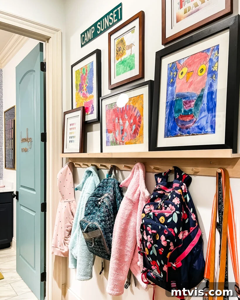 Transform Your Space: 27 Gallery Wall Ideas and Practical Hacks 17 A cheerful mudroom gallery wall showcasing a collection of children's artwork, bringing vibrant color and personal charm to a functional family space.