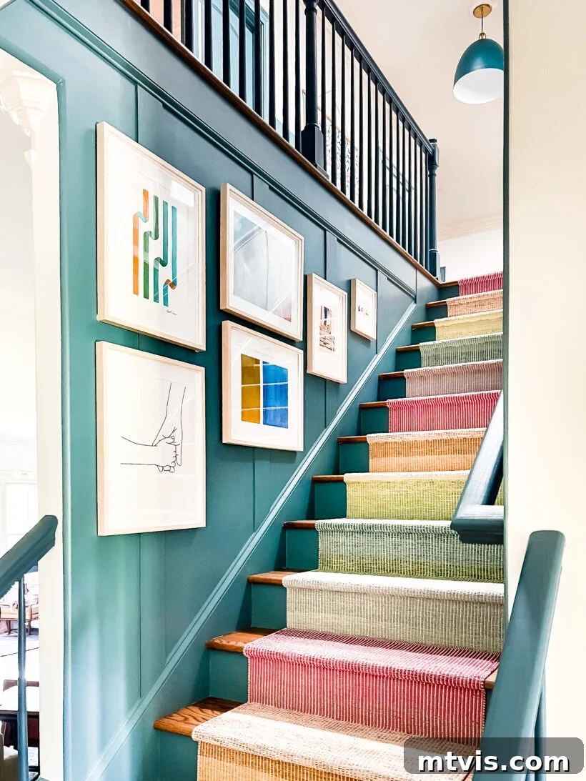 Transform Your Space: 27 Gallery Wall Ideas and Practical Hacks 8 A colorful and eclectic art gallery wall adorning a staircase, with diverse pieces arranged to follow the ascending line of the stairs, creating a vibrant focal point.