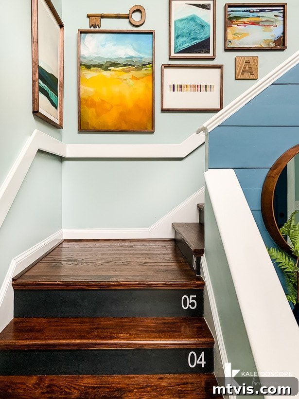 Transform Your Space: 27 Gallery Wall Ideas and Practical Hacks 9 A charming wooden staircase adorned with a gallery wall featuring colorful art arrangements in DIY frames, blending seamlessly with the home's aesthetic.