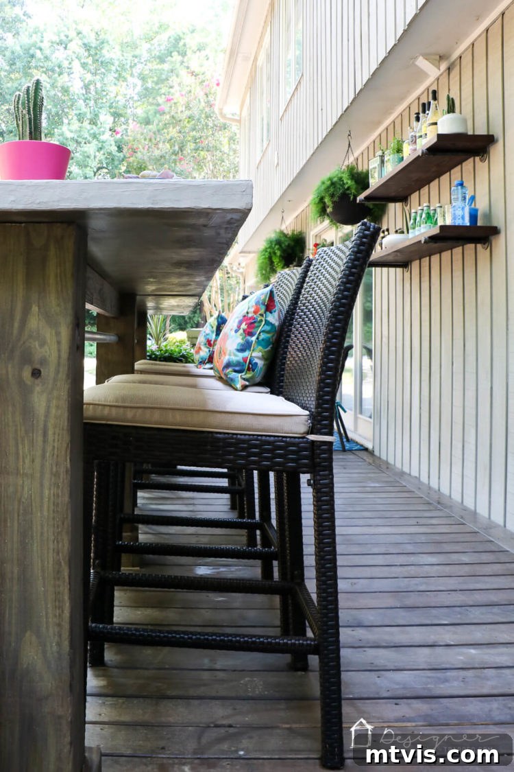 An inviting view of the deck’s seating area, showing the comfortable outdoor rockers and a glimpse of the DIY bar, perfect for social gatherings.