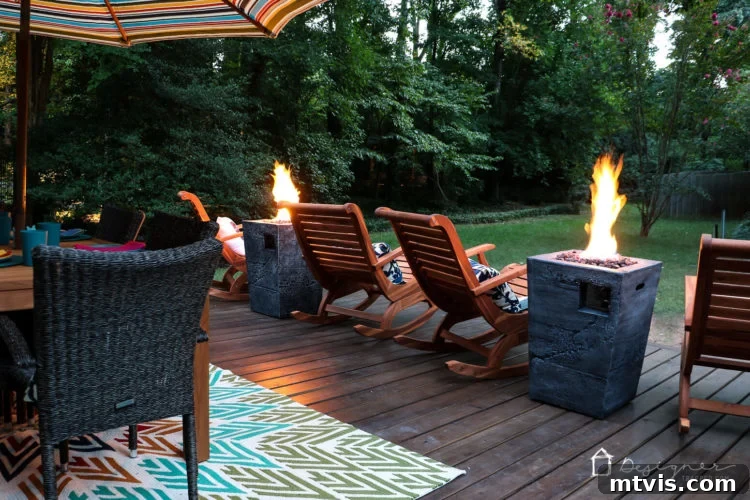 A serene evening shot of the deck, highlighting the cozy corner with the fire columns and rocking chairs, perfect for peaceful outdoor enjoyment.