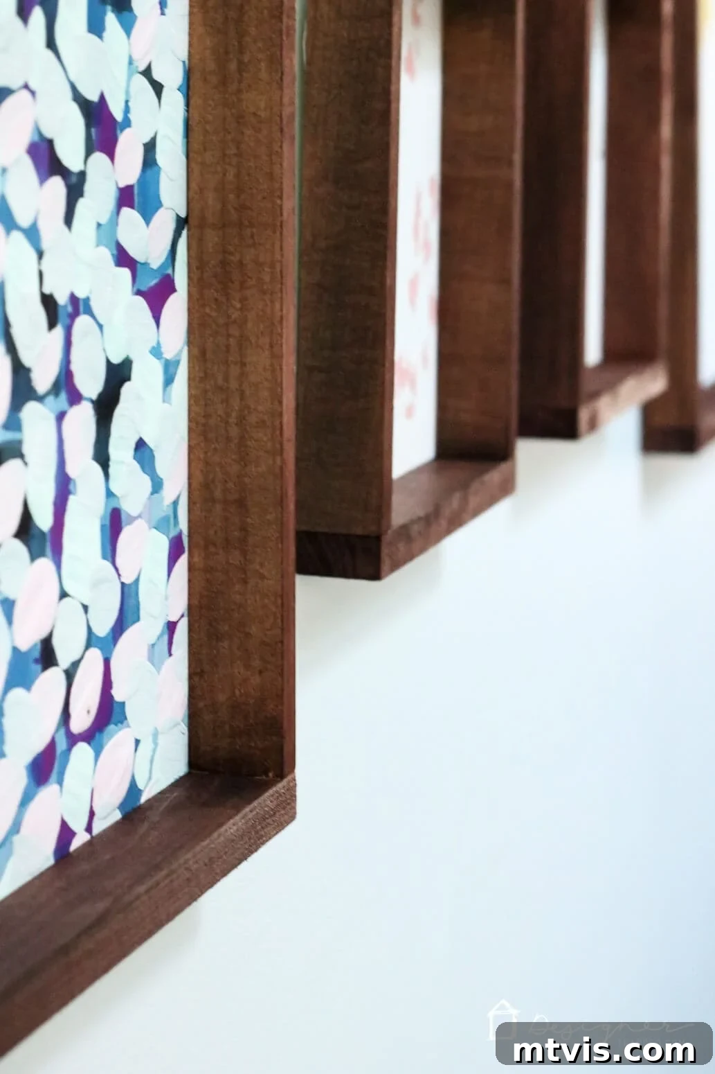 Build Custom Frames for Your Oversized Art 14 A detailed angled shot of multiple wall art frames, highlighting their rich, dark wood stain and the seamless construction of these homemade picture frames, a testament to the DIY tutorial's effectiveness.