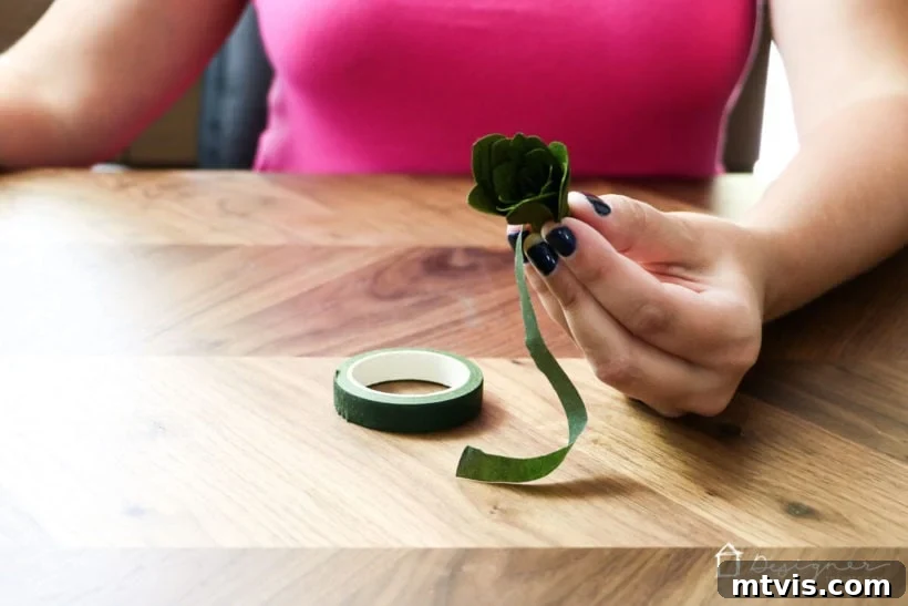 The Cricut Edge Perfecting Crepe Paper Succulents 8 Securing the base of the crepe paper succulent with floral tape for stability.