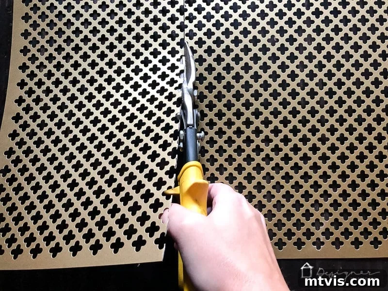 Accurately mark and cut your decorative aluminum sheet using tin snips for a clean and precise edge, essential for your DIY kick plate.