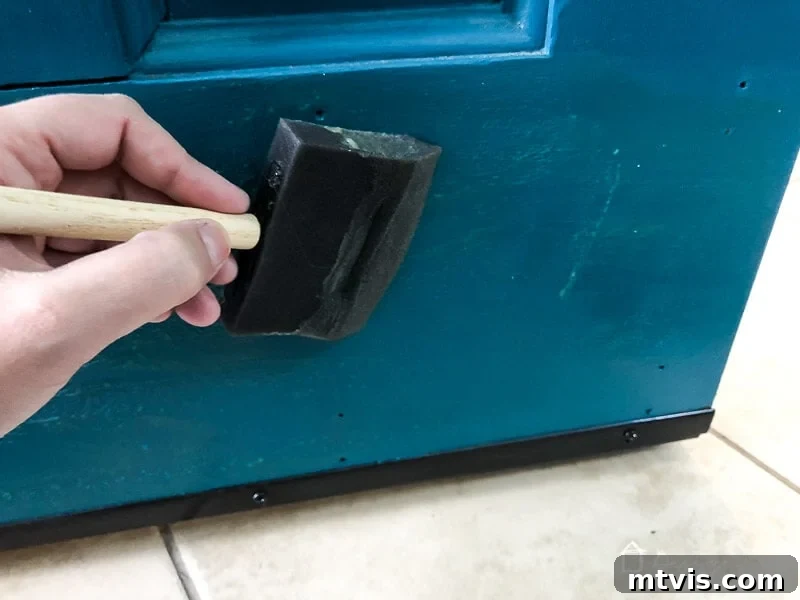 Ensure both surfaces, the door and the kick plate, are coated with contact cement and allowed to dry to the recommended tackiness.