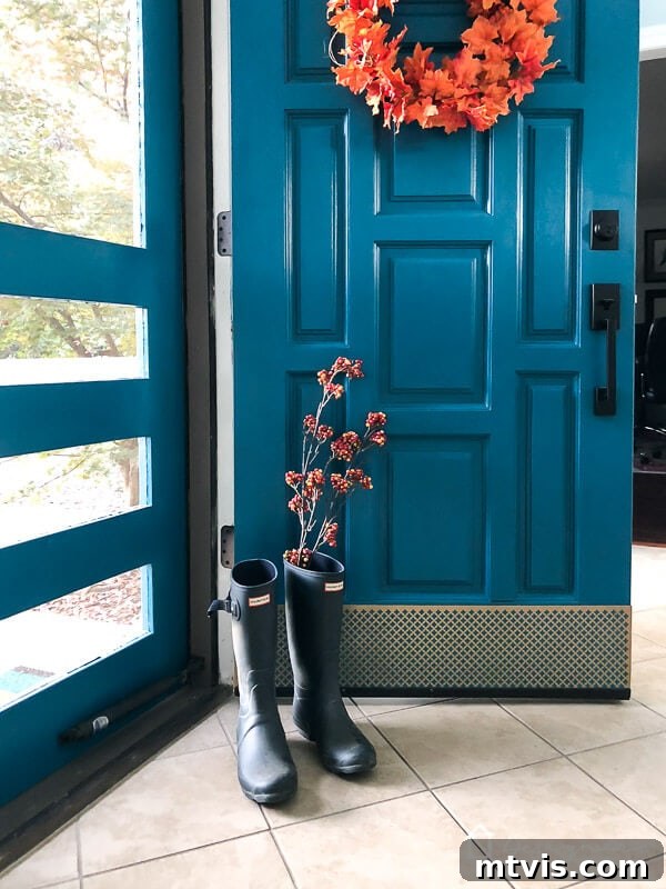 Quick & Easy Door Kick Plate Project 8 The finished DIY kick plate shines, adding a beautiful gold accent to the blue front door, merging protection with elegant style.