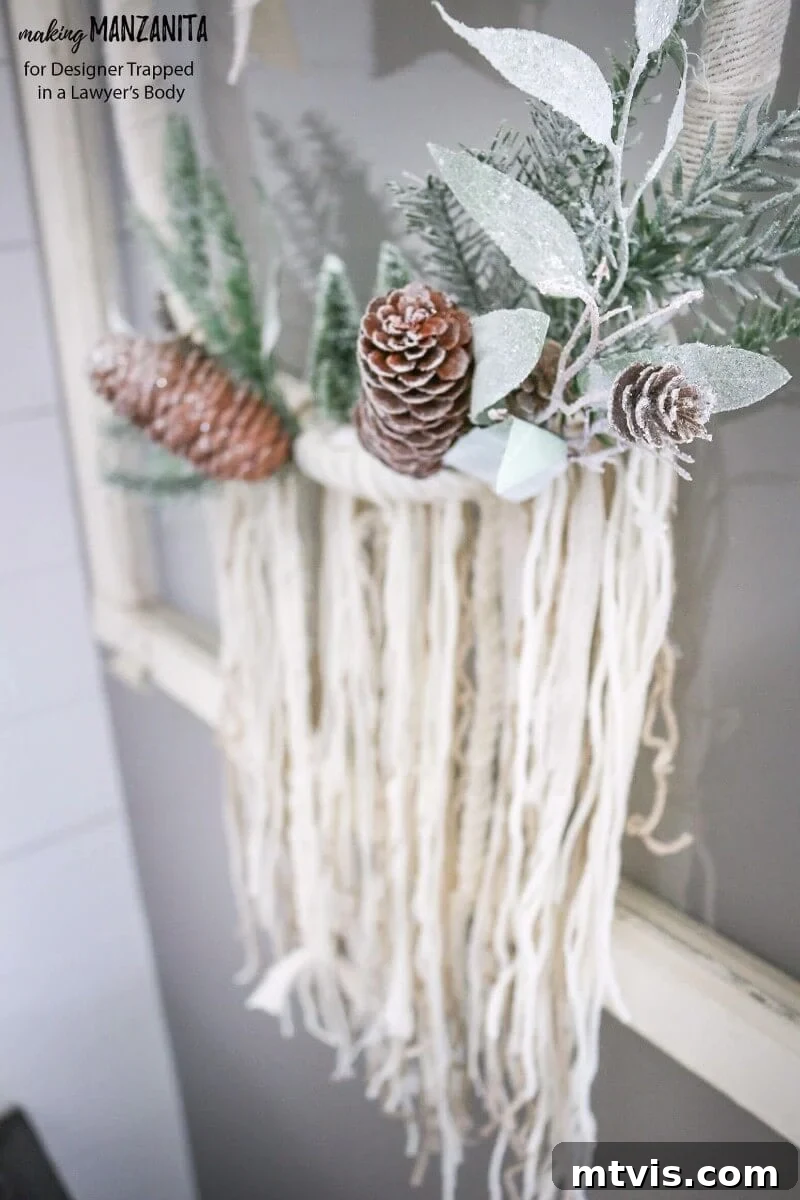 Craft Your Boho Winter Wreath 12 A close-up of the elegant DIY Boho Winter Wreath, highlighting the blend of soft fabric, yarn, and frosted elements, perfect for creating a serene and stylish winter atmosphere in any room.