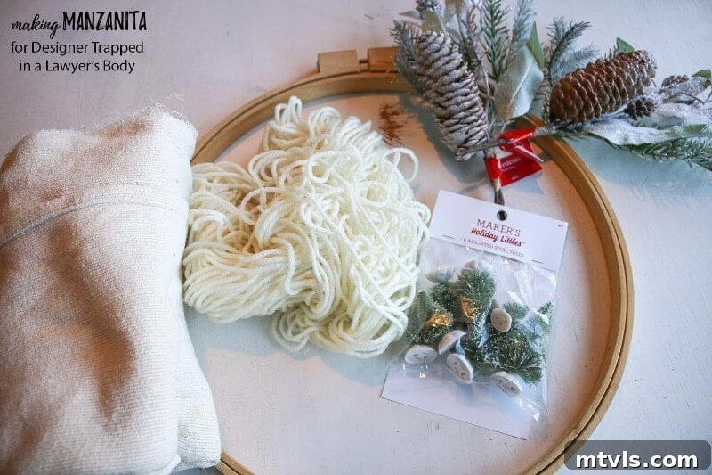 Craft Your Boho Winter Wreath 3 Gather your supplies to create a budget-friendly DIY Boho Winter Wreath. You'll need an embroidery hoop, soft fabric, yarn, mini sisal trees, floral picks, floral wire, hot glue, and scissors for this easy craft project.