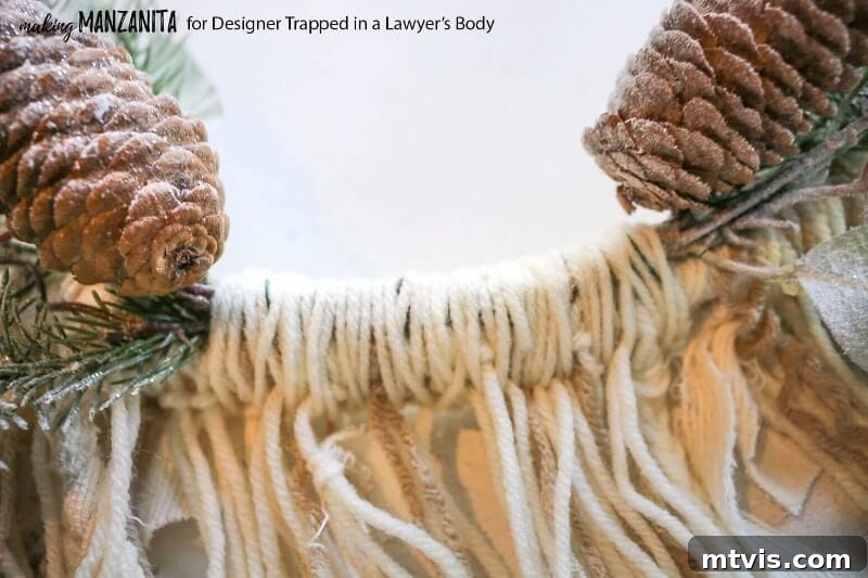 Craft Your Boho Winter Wreath 8 Conceal the exposed floral wire on your DIY Boho Winter Wreath by carefully wrapping it with additional yarn. Weave the yarn through the hanging strands for a polished finish, adding texture and hiding any unsightly elements.