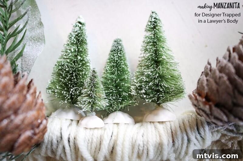 Craft Your Boho Winter Wreath 9 Hot glue miniature sisal trees onto the inner ledge of your DIY Boho Winter Wreath, placing them strategically between the floral picks to create a charming winter focal point.