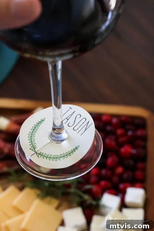 Close-up of a DIY wine glass charm with a laurel design, showcasing the detailed pen work and clean cut.
