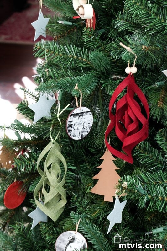 Craft Charming Felt Ornaments for Christmas 9 Two unique handmade felt Christmas ornaments, in different colors, artfully displayed on a decorated Christmas tree.