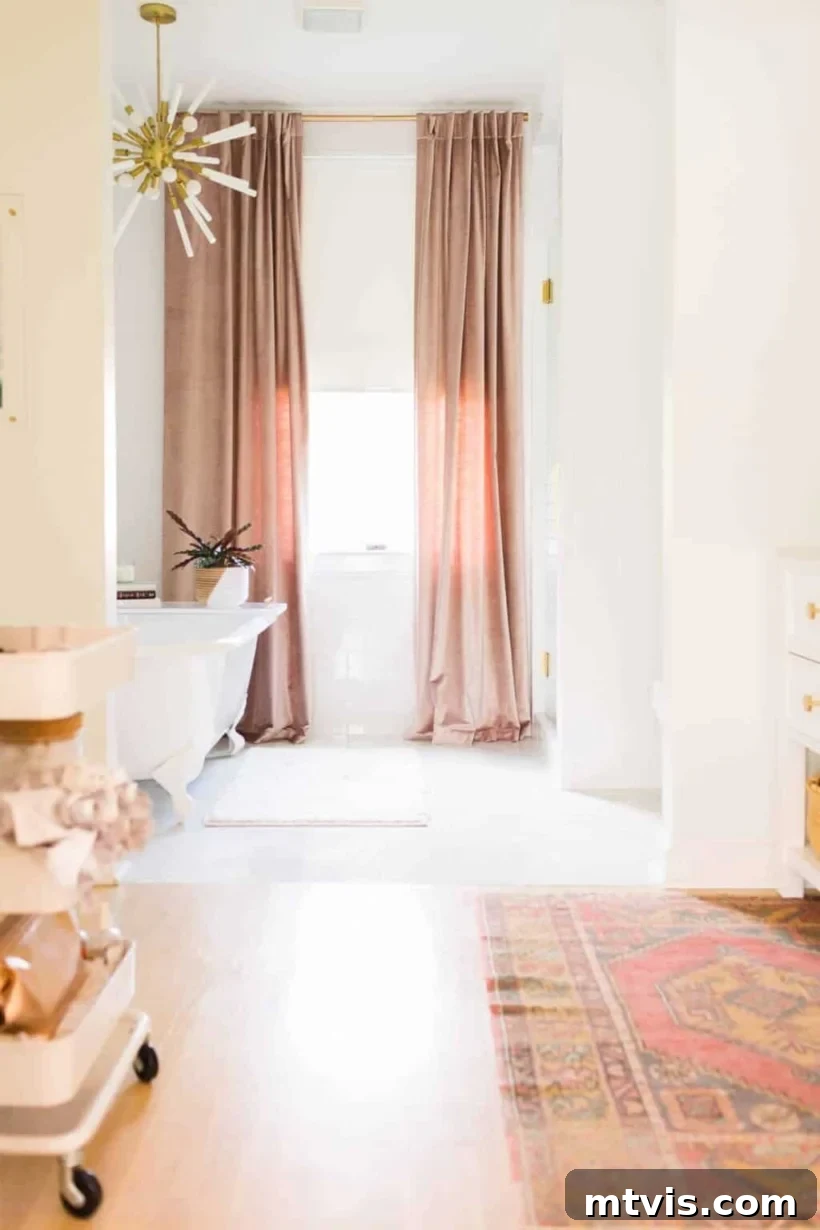 Space-Saving Secrets: 9 Genius Hacks for Bigger-Looking Rooms 5 Floor to ceiling curtains frame a sunny window against the back wall of a long primary bathroom. Photo courtesy of "A Beautiful Mess." This clever use of window treatments makes the bathroom feel more expansive and luxurious.
