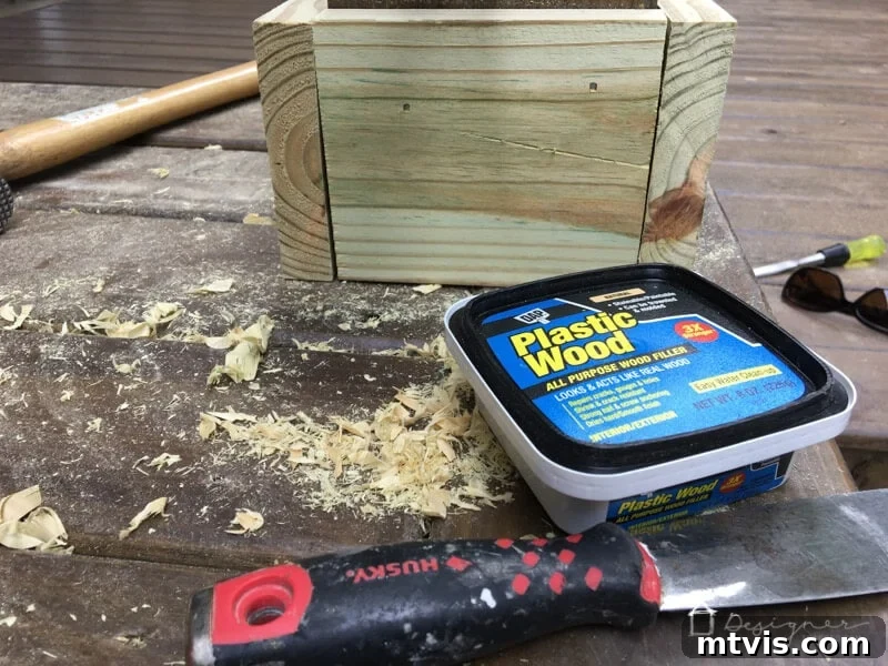 The Art of Invisible Hole Repair 3 Applying wood filler with a putty knife to cover nail holes for a smooth finish