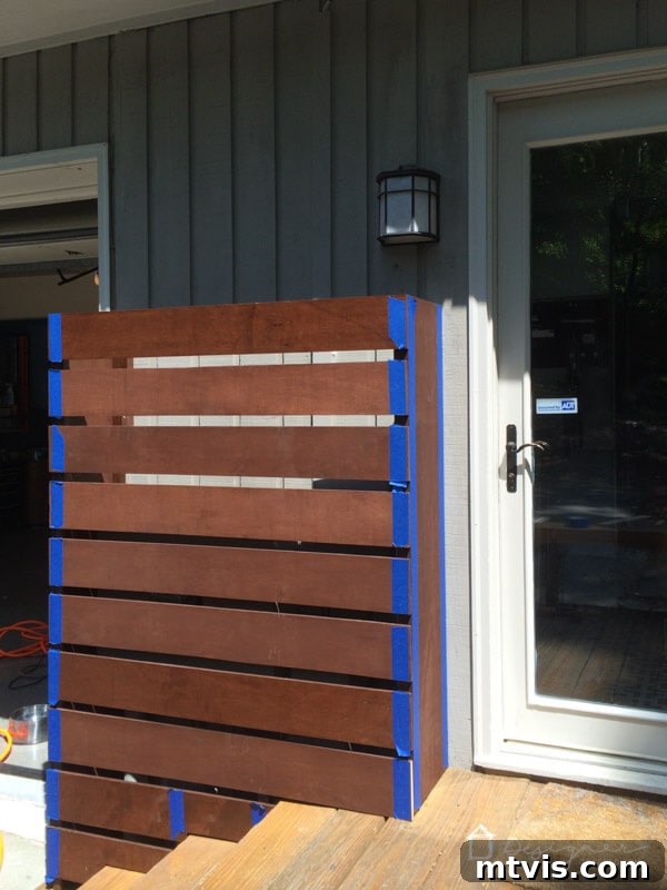 The Art of Invisible Hole Repair 5 Taping off pre-stained wood before driving screws to protect the finish