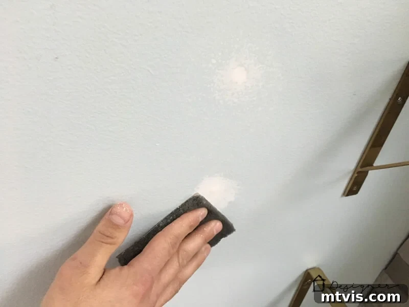 How to Repair Drywall: Tips for Minor Repairs 4 sanding spackle after drywall repair